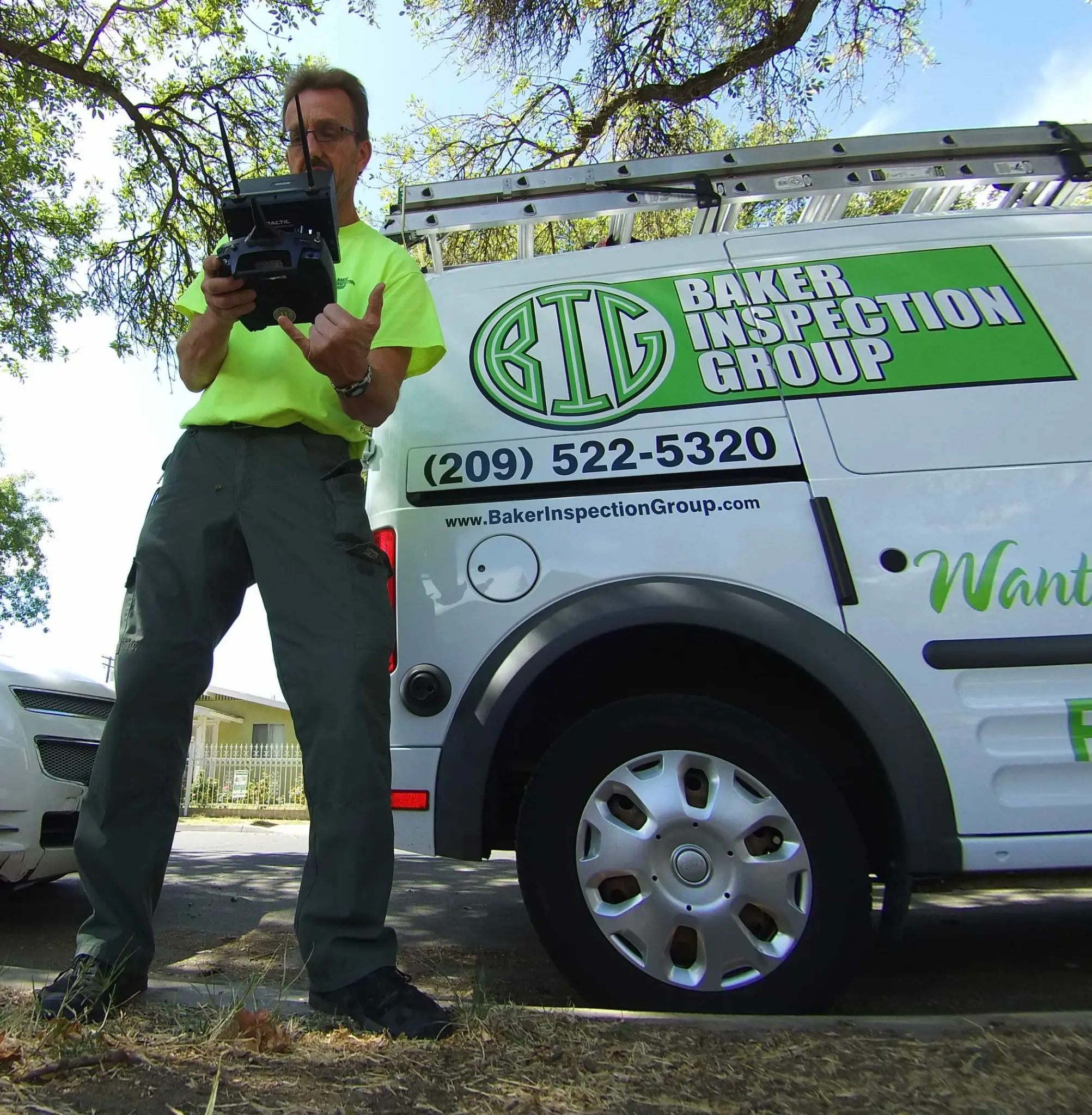 Scot Baker operating inspection equipment beside his Baker Inspection Group vehicle