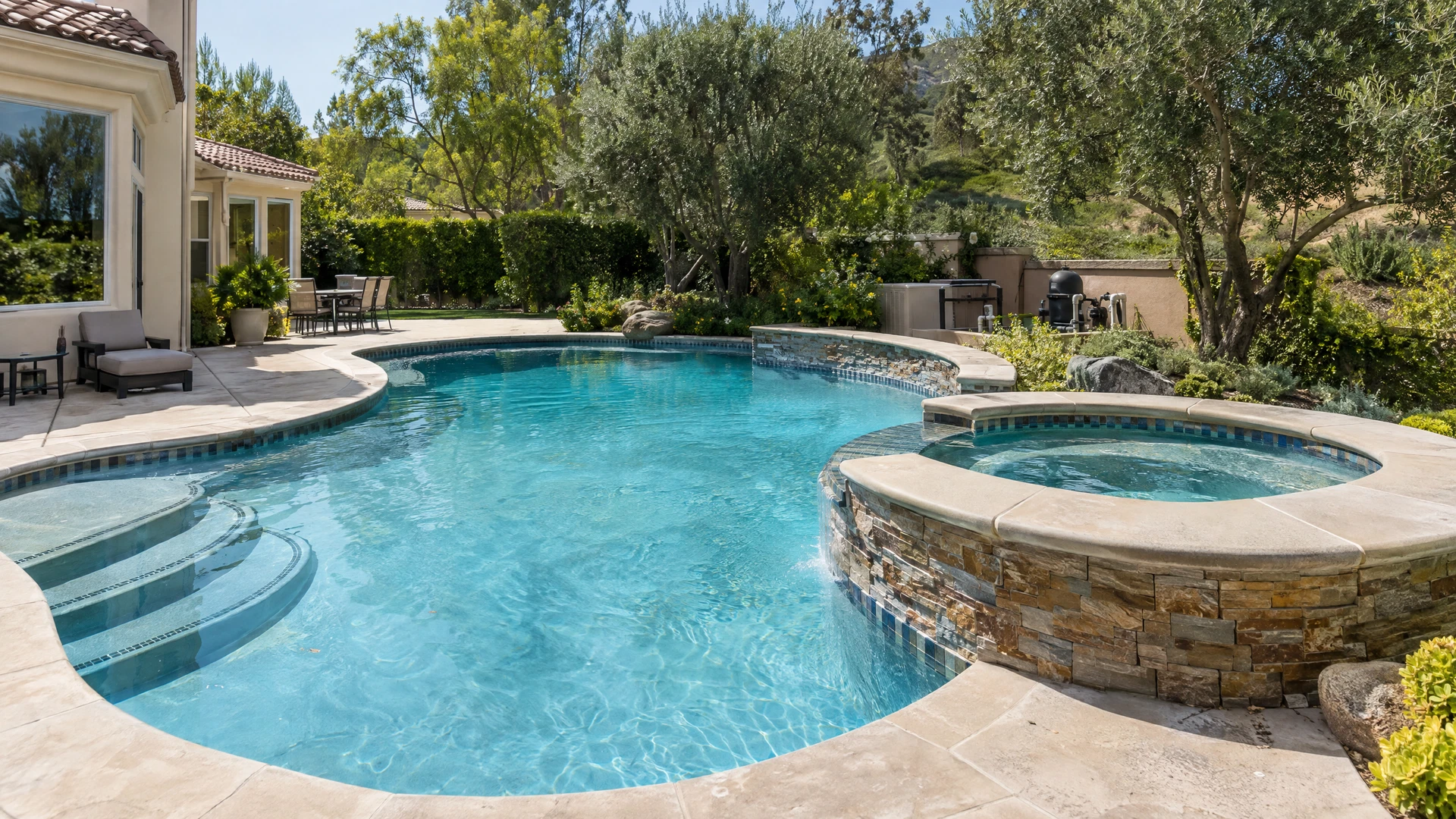 Residential swimming pool and attached spa with visible coping and entry steps
